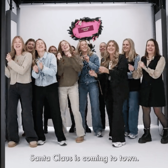 Still van de video 'all you need is My Jewellery'. Je ziet het content team in de styleshoot dansen met een roze bord erachter waarop hun team naam staat