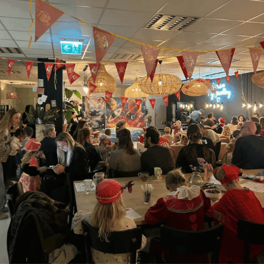 Colleagues with their children at the My Jewellery Headquarters in ’s-Hertogenbosch watching a Pieten show with Sinterklaas.