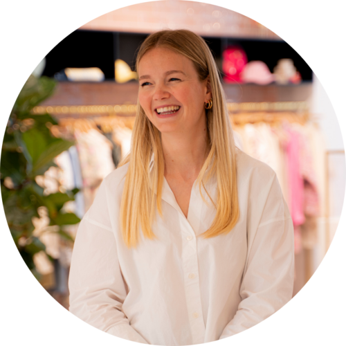 Maud van Lanen, HR-Coördinator, Smiling at the camera in the showroom.